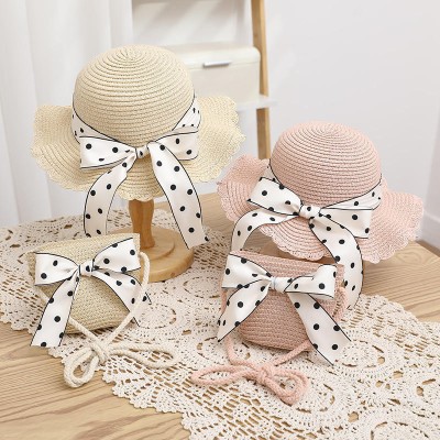 Women's woven straw hat with bow tie and wide brim