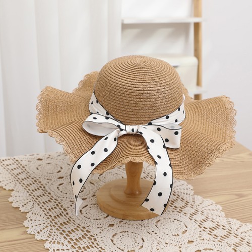 Women's woven straw hat with bow tie and wide brim